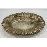 A .800 grade silver oval dish, with relief moulded floral decoration to rim, 30cm diameter, gross