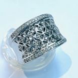 A 9ct white gold wide-band dress ring, set with 70 x small round brilliant cut diamonds in a criss-