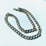 A 9ct gold curb chain, weighing 42.0 grams, measuring 20 inches.