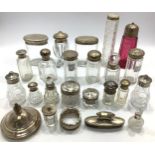 Nineteen various silver-topped or silvered collared glass and cut glass toilet jars, including a