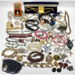 A large collection of various costume jewellery, including bracelets, bangles, earrings, brooch, and