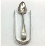 A pair of Georgian silver sugar tongs and a Georgian silver spoon, both by Peter, Ann & William