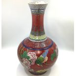 A Qing Dynasty Chinese porcelain vase of globular form with tall flared neck, incised and painted in