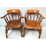 Two various elm captain's chairs, of typical form with spindle backs, curved top rail and raised