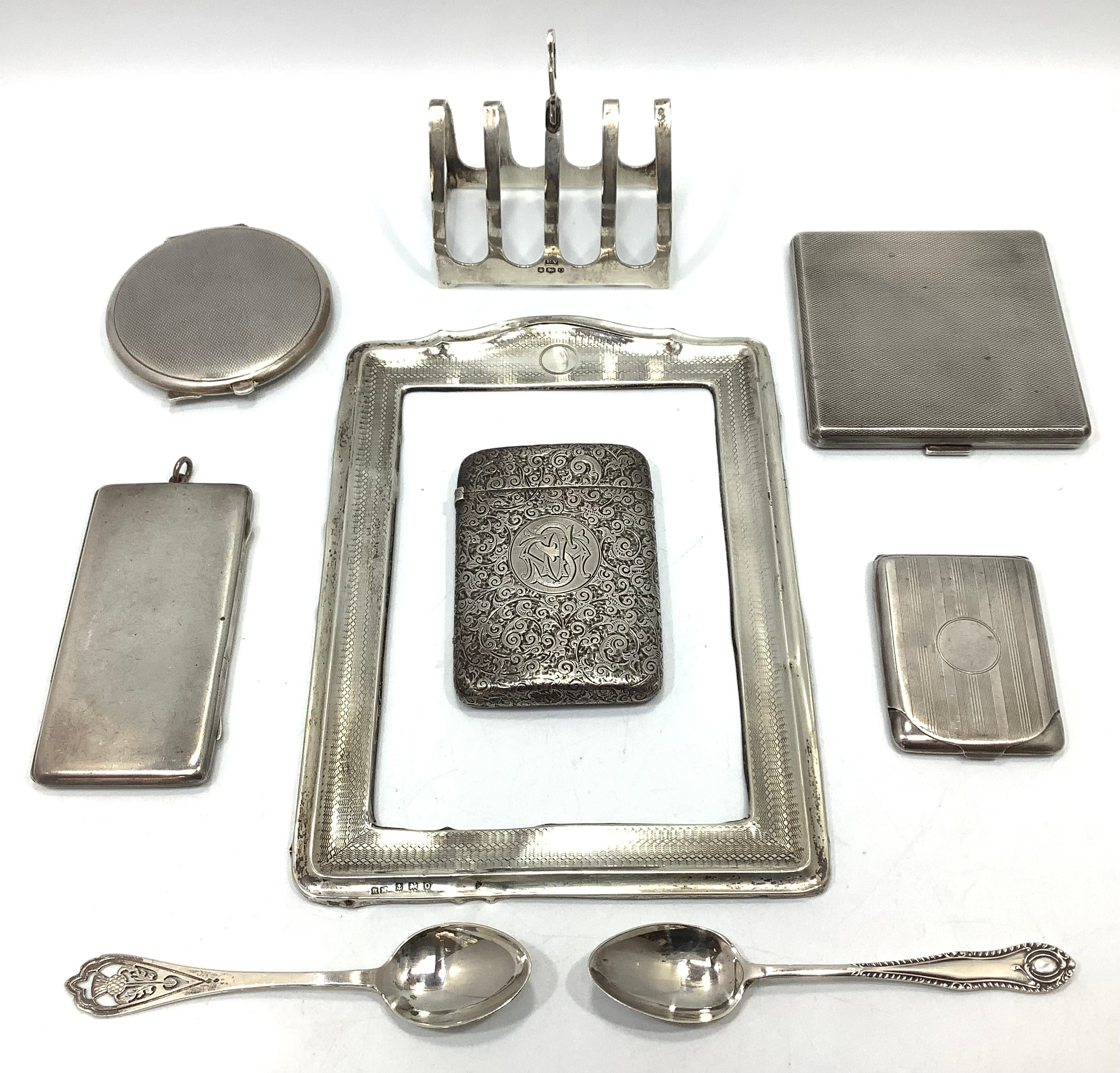 A quantity of silver items including a Victorian cigarette case with foliate decoration and