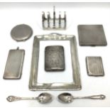 A quantity of silver items including a Victorian cigarette case with foliate decoration and