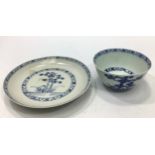 A Chinese Nanking cargo blue and white tea bowl and saucer in the 'Blue Pine' pattern, each with