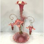 A Victorian Cranberry and opaque white cased glass epergne with three trumpet stem vases and two