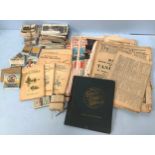 A large quantity of cigarette cards together with some postcards, stamps and old newspapers