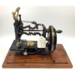 A James Weir small sewing machine circa 1870, with cast body painted with gilt floral sprays,