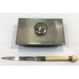 A silver bladed letter opener with ivory handle and globe finial inset with a flower, Sheffield,
