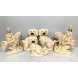 A pair of Staffordshire pottery seated spaniels, and another, together with a pair of