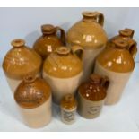 Eight various stoneware pottery flagons, with printed and impressed names including Aylward &