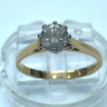 An 18ct yellow gold solitaire diamond ring, the round brilliant cut diamond being I in colour, SI2