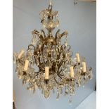 A large ornate two-tier ten-branch chandelier with etched glass faux 'drip pans,' and cut glass