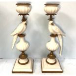 A pair of porcelain and metal-mounted candlesticks modelled with birds, approx. 57cm high