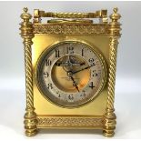 A brass carriage clock by Howell & James Ltd, the dial with exposed escapement and silvered