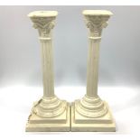 A pair of Creamware pottery candlesticks modelled as classical composite columns, approx. 30cm high