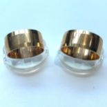 Two 9ct gold wide wedding bands, both 9mm, total weight 9.9 grams.