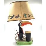 A Carltonware pottery Guinness lamp modelled as a toucan and a glass of Guinness.