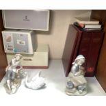 Three various Lladro porcelain figures including a girl with a dog on her lap, a seated lad with dog