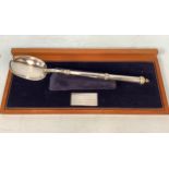 A large canon handled, 'rat tail' silver basting spoon by Royal Irish Silver Ltd, bearing import