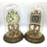 Two various German Schatz 400 Day Clocks, both with Arabic numerals denoting hours, raised on two