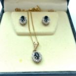 A 9ct yellow gold sapphire and diamond pendant and chain, together with matching earrings, total