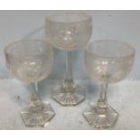 A 19th century Bohemian glass garniture of three stemmed goblets, the bowls cut and etched with