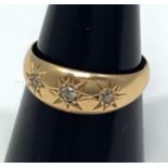 An 18ct gold gypsy set ring with three diamonds, 3.7g, ring size P/Q