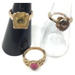 Three 9ct gold dress rings including a square citrine, oval smoky quartz and a cabochon pink stone