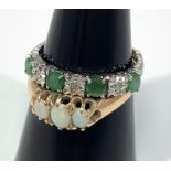 A 9ct white gold ring set with four emerald coloured stones and three small diamonds, together