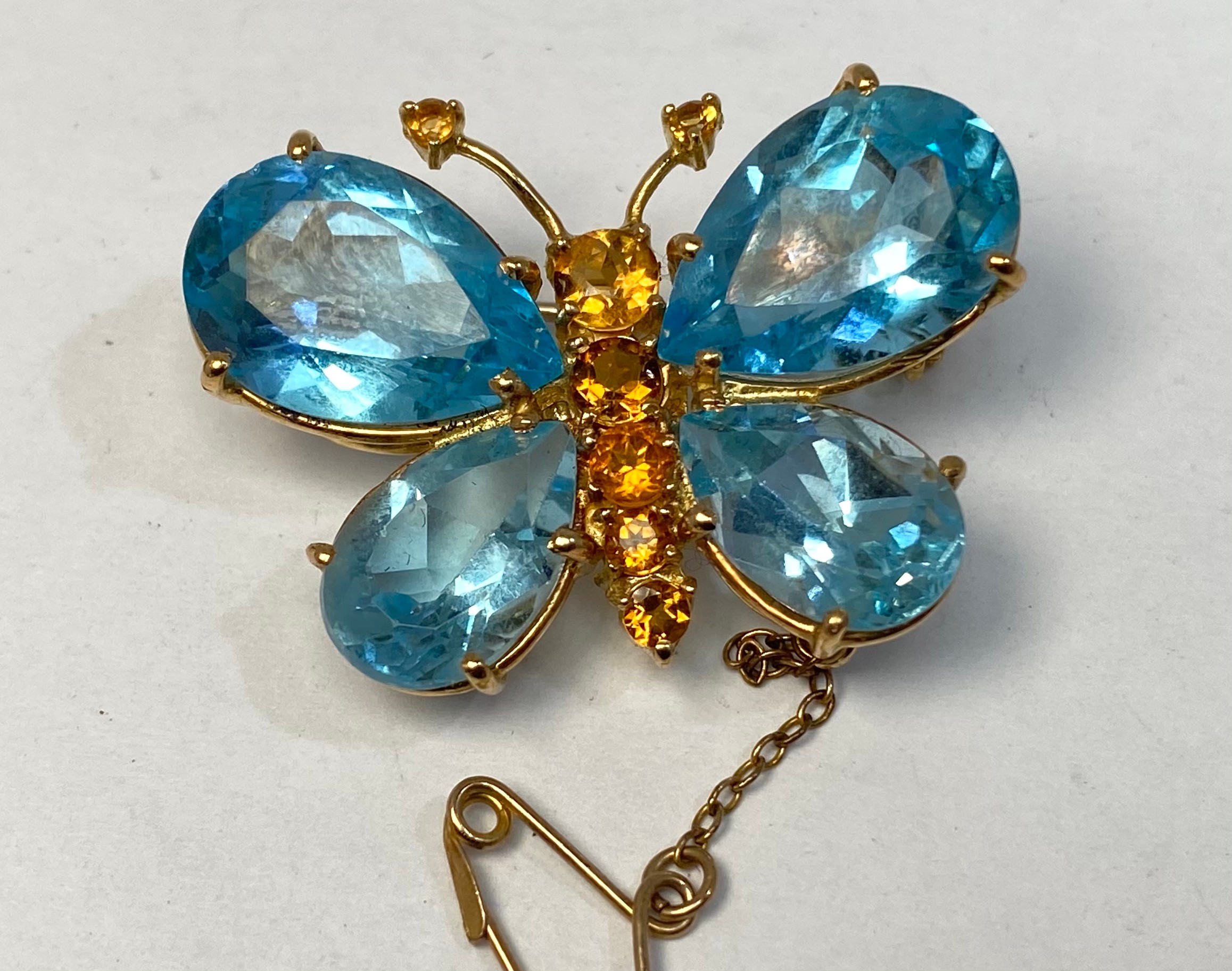 An 18ct gold brooch, modelled as a butterfly, the wings set with pear-shaped aquamarines, and the