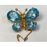 An 18ct gold brooch, modelled as a butterfly, the wings set with pear-shaped aquamarines, and the