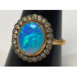 An 18ct gold, opal and diamond ring, set with an oval fiery opal, measuring 12mm x 10mm,