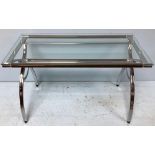 A contemporary chrome and wood effect desk, with glass top, raised on x-shape supports with