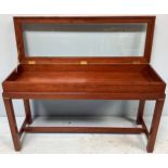 A contemporary mahogany campaign style bijouterie table, of rectangular form, with hinged,