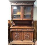 A 19th century French walnut bookcase, the shaped cornice with dentil moulding to a carved, relief