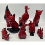 Nine various Royal Doulton flambe animals including an Emperor penguin, 15cm high, seated cat, two