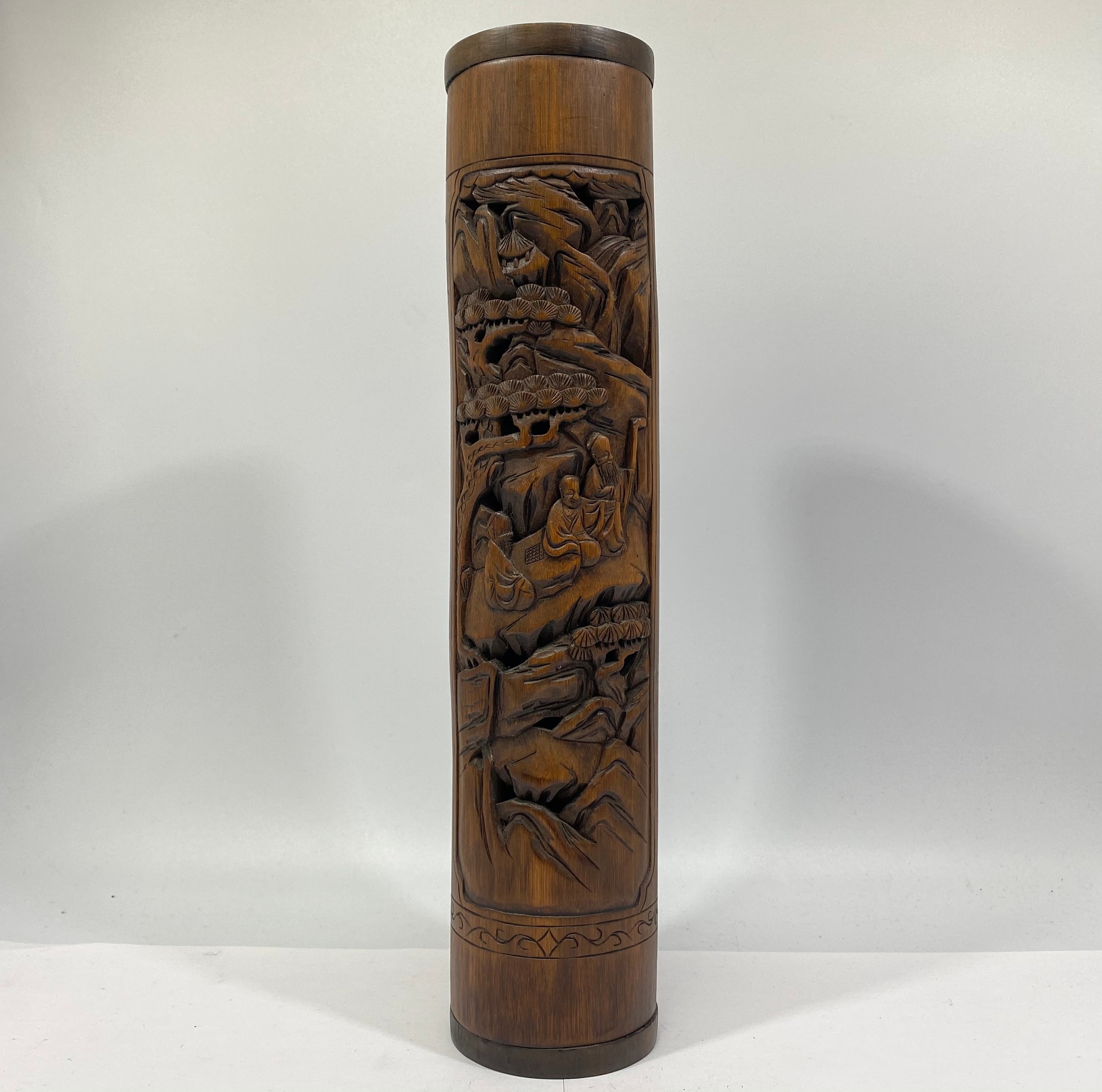 A late Qing Dynasty Chinese Bamboo Incense Holder, carved with three immortals in a mountain