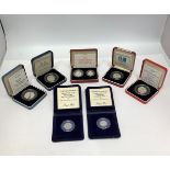 A collection of assorted Royal Mint proof-struck, silver coins including four various fifty pence