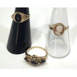 Three 9ct gold dress rings including a cameo, a black onyx signet ring and another set with small