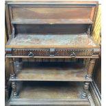 A 19th century French walnut buffet, the hinged top enclosing a rouge marble work surface, with