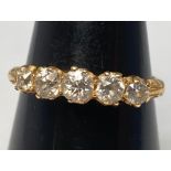 An 18ct yellow gold five-stone graduated diamond ring, set with five old cut diamonds in a claw