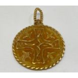 An 18ct gold disc pendant cast with a Celtic cross to the centre, weighing 6.8 grams.