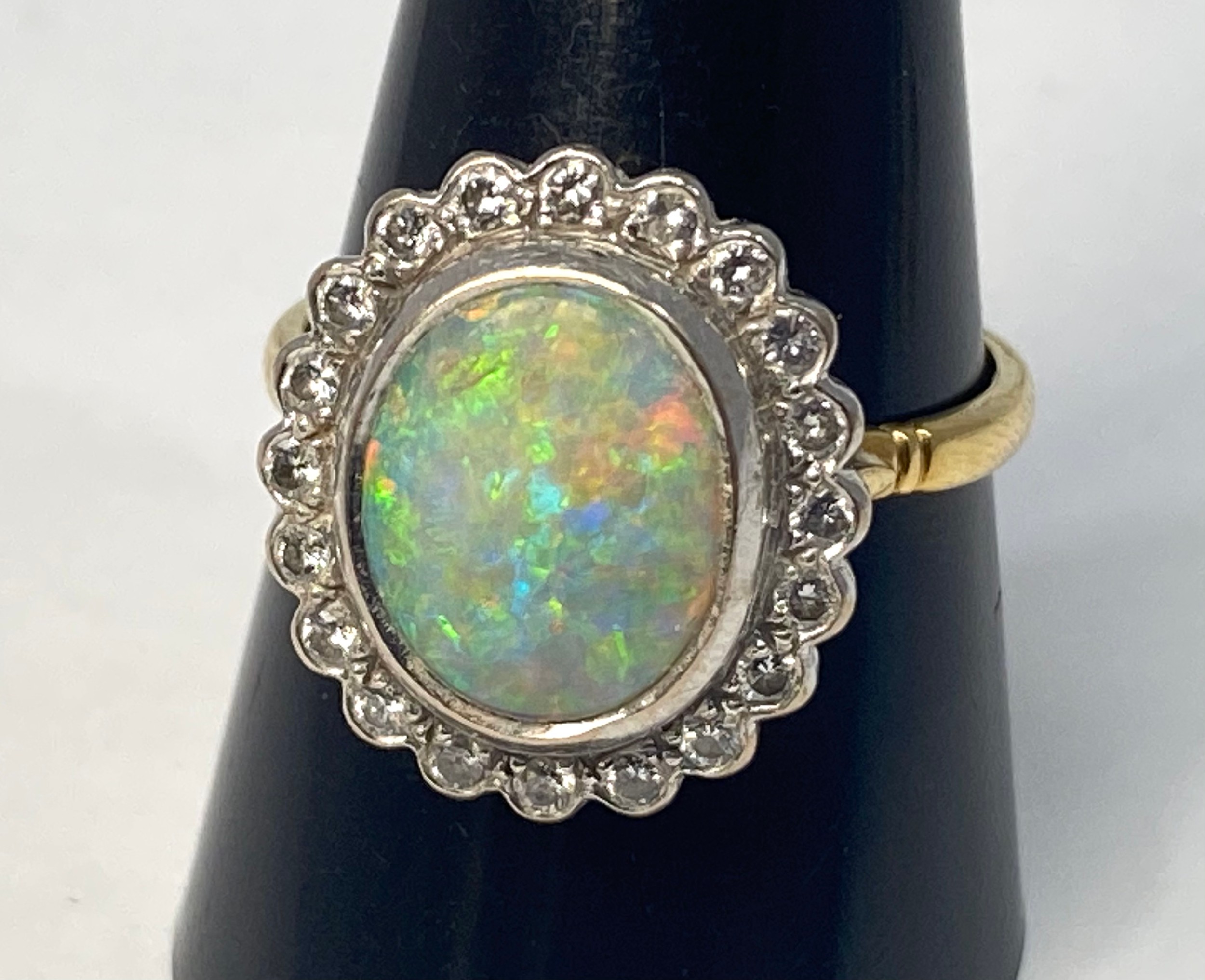 An 18ct gold opal and diamond ring, set with an oval fiery opal, measuring approximately 14mm x - Bild 5 aus 5