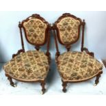A pair of Victorian carved and turned nursing chairs with stuff-over-seats and padded backs, ceramic