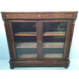 A late Victorian inlaid burr walnut two - door display cabinet, with brass beading and floral