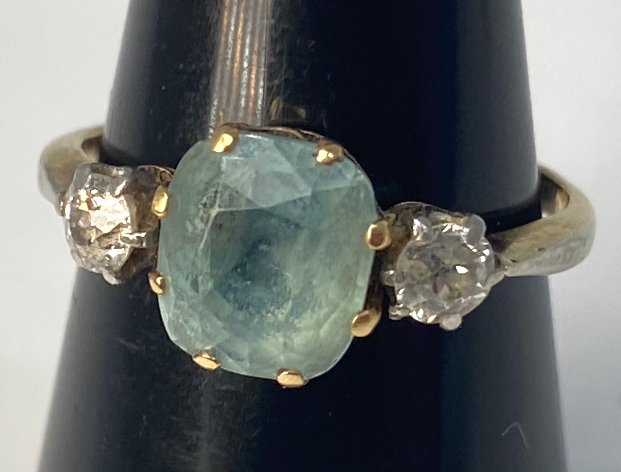 A 9ct gold ring, set with a cushion cut aquamarine in a claw setting, ring weighs 2.7 grams,