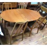 Four Nathan dining chairs with drop-in seats and matching oval drop-leaf table.